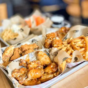 a tray of chicken wings and french fries