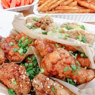 a platter of chicken wings and french fries