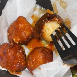 Burnt. Looks like meatballs. Were cold.