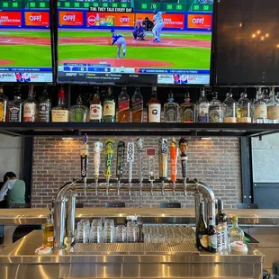 a baseball game being played on tvs
