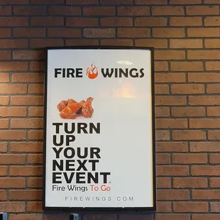 a poster on a brick wall