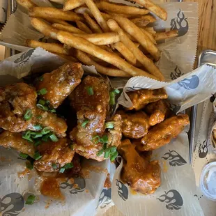 Bone in wings with seasoned fries.