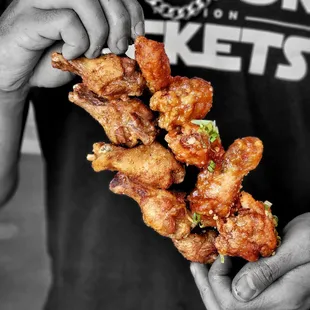  a man holding a pile of chicken wings