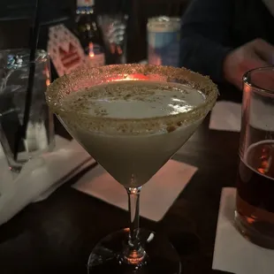 a glass of cocktail on a table