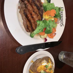 Aged Ribeye (12oz), fresh vegetables, loaded baked potato.