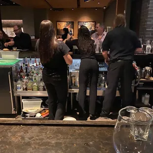 a group of people at a bar