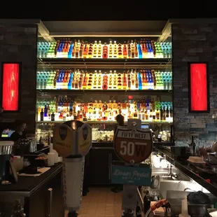 A very colorful well stocked bar.