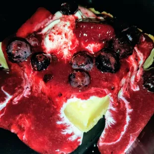 Ooey Gooey Butter Cake topped w/ ice cream, blueberries, and strawberries.