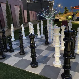 Small human sized chess set.