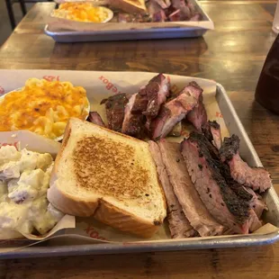 a tray of meat, macaroni, and cheese