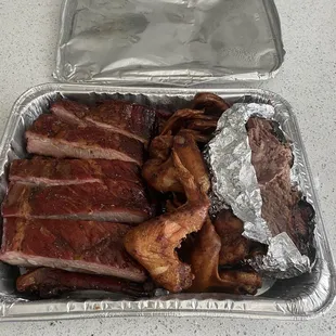 Full rack of Pork Ribs, 8 chicken wings, and 1 lb. Beef Brisket