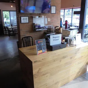 Front counter and til, on the right when you walk in.