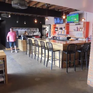 Side view of the entryway, bar, and kitchen window.