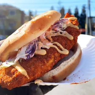 a chicken sandwich with coleslaw slaw