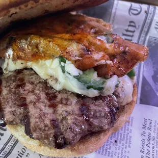 Jalapeño popper burger. It looks like bacon but it&apos;s torched pepper Jack cheese (see review).