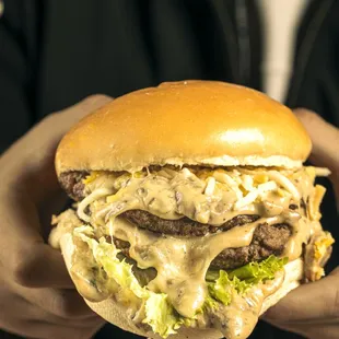 a person holding a hamburger