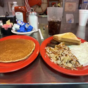 Three eggs over easy with hash browns, sausage and a pancake !