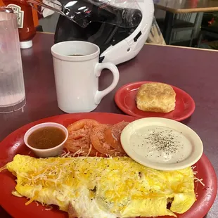 Loaded omelette, tomato slices, and biscuit w/gravy.  Absolutely delicious. The biscuit was so light &amp; fluffy it almost floated away.