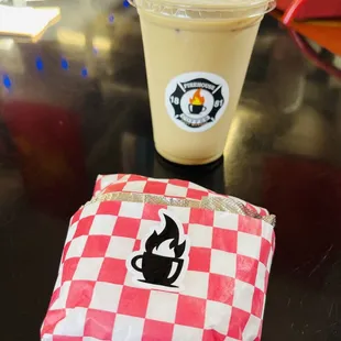 a red and white checkered bag and a drink