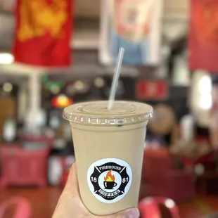 a hand holding a cup of coffee