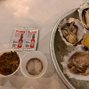 Mignonette, salt &amp; pepper, Tabasco sauce packets, and lemon wedges for oysters