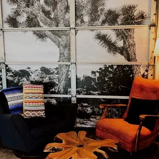 a living area with a couch, chair, coffee table and television