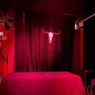 a red lit room with a red tablecloth