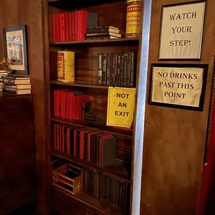 a bookshelf with books and signs