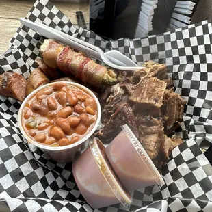 Two meat plate with brisket, sliced brat. Two sides which were bacon wrapped jalapeño's and western beans with brisket.