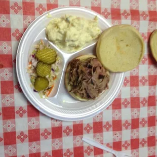 Pork sandwich with potato salad and slaw