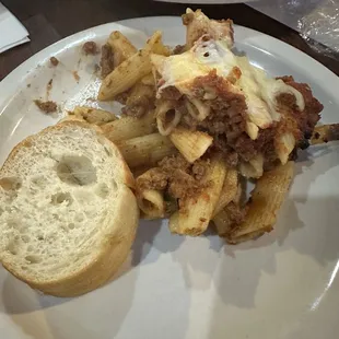 Lasagna with penne noodles, bread, mashed potatoes, green beans, and broasted chicken.