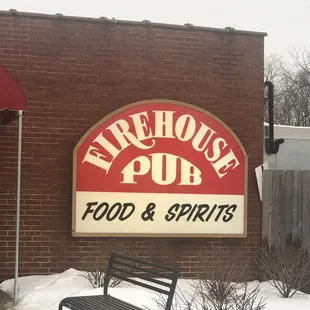 a bench in front of the sign