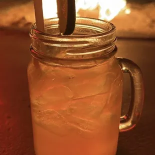 a mason jar with a straw and a lime slice in it