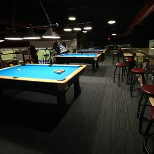 The loft seems like an intimate place to play pool. You can still see the tv.