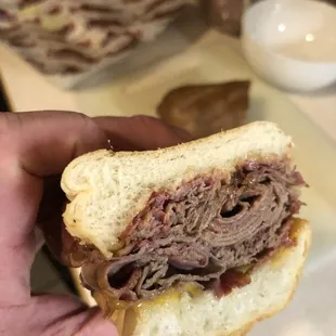 a hand holding a sandwich