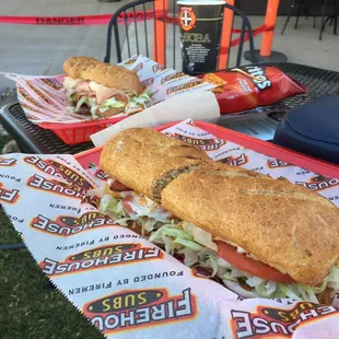 two sub sandwiches on a table