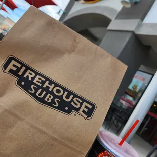 a paper bag with a drink in it