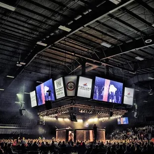 a large crowd of people watching a concert