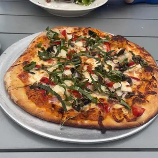 Tuscan Apple salad and pizza made with cherry tomato sauce and topped with chicken, mushrooms, onions, roasted red peppers and basil.