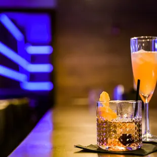 two cocktails on a bar