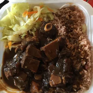 Oxtail with rice and peas, side of cabbage. This huge portion is the small! Was delicious