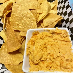 a basket of chips and dip