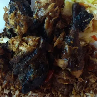 Jerk Chicken (very charred) over Rice and Peas, with cabbage.