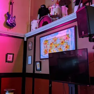 a tv and a television in the corner of a room