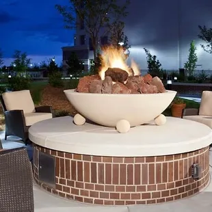 a fire pit in the middle of a patio