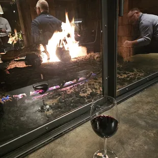 a glass of wine and a fire