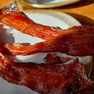 two slices of bacon on a plate