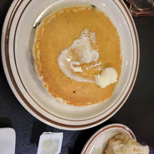 a bowl of soup and a plate of bread
