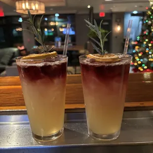 two cocktails on a bar
