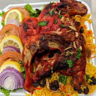 grilled chicken and vegetables on a bed of rice